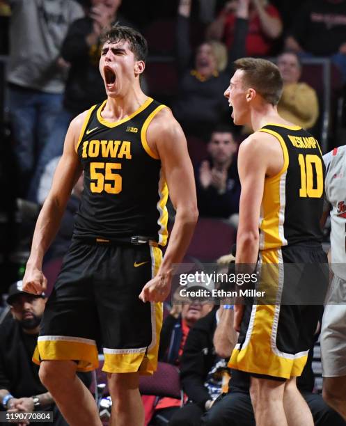 Luka Garza and Joe Wieskamp of the Iowa Hawkeyes react after Garza scored and got a foul call against the Texas Tech Red Raiders during the 2019...