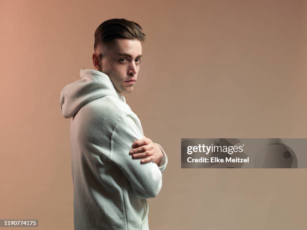 young man turning around towards camera - hipster man stock pictures, royalty-free photos & images