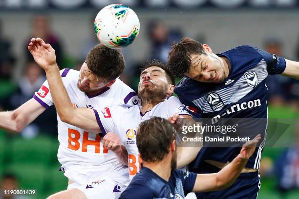 Bruno Fornaroli of the Glory heads the ball against James Donachie of the Victory during the round eight A-League match between the Melbourne Victory...