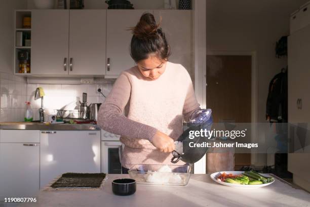 woman preparing food in kitchen - making sushi stock pictures, royalty-free photos & images