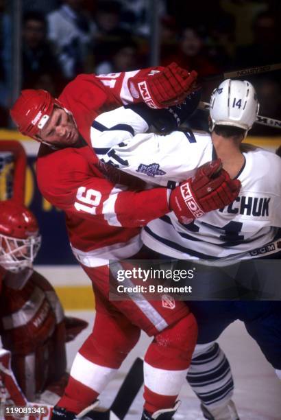 Vladimir Konstantinov of the Detroit Red Wings checks Dave Andreychuk of the Toronto Maple Leafs in front of the net during their game circa 1995 at...