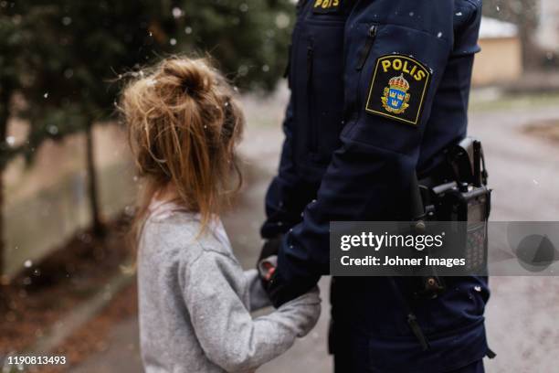 police woman hugging daughter - swedish police woman stock-fotos und bilder