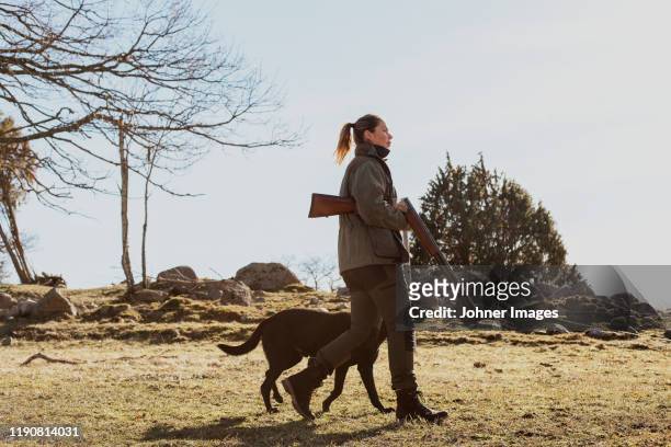 woman with dog - jaeger stock-fotos und bilder