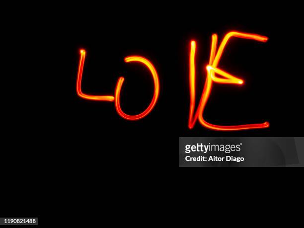 love written with red light on a black background - black light burns stock pictures, royalty-free photos & images
