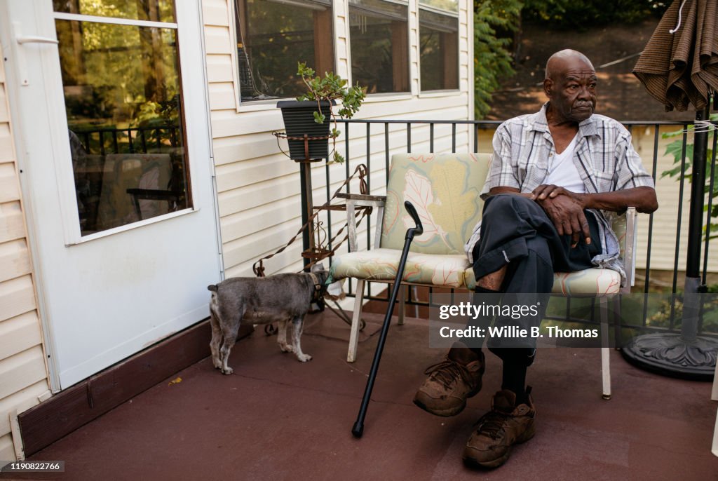 Senior black man sitting on his front porch