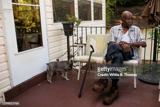 senior black man sitting on his front porch - stoop stock pictures, royalty-free photos & images