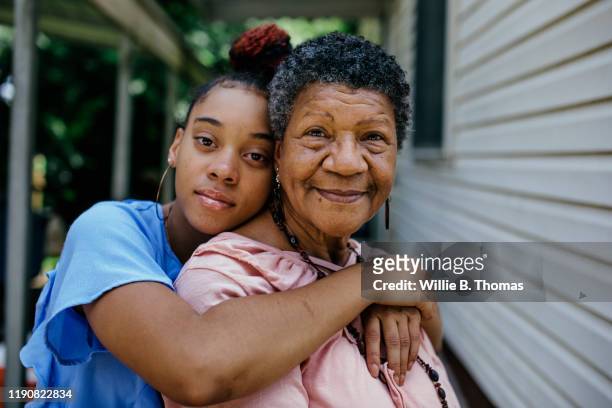 portrait of black grandmother with teenager granddaughter - multi generation family stock pictures, royalty-free photos & images