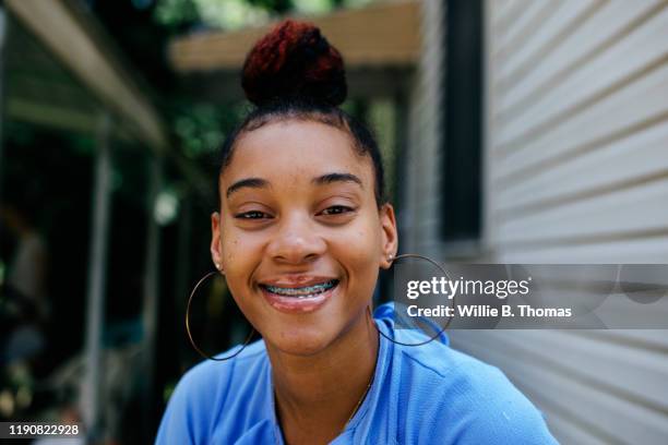 close-up of smiling black teenage with braces - hoop earring fotografías e imágenes de stock