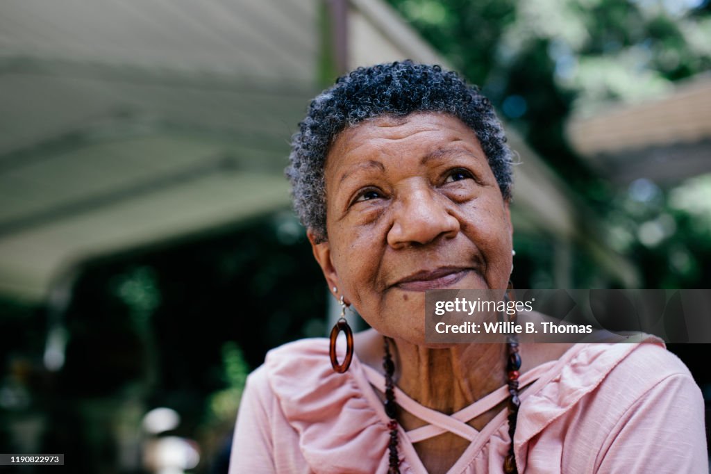 Close-up portrait of senior black woman looking thoughtful