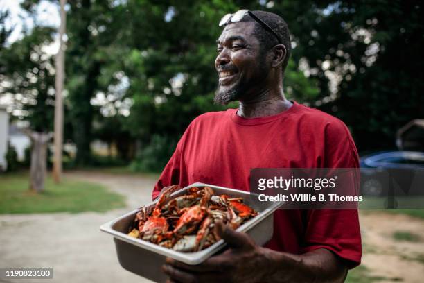 Close-up of black man with cooked Crabs