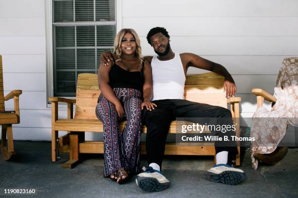 young black couple relaxing on a front porch - middle class female stock pictures, royalty-free photos & images