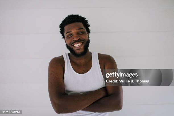 portrait of smiling young black man - hemden stockfoto's en -beelden