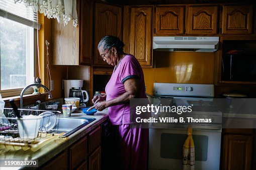 Senior black woman making breakfast Senior black woman making breakfast