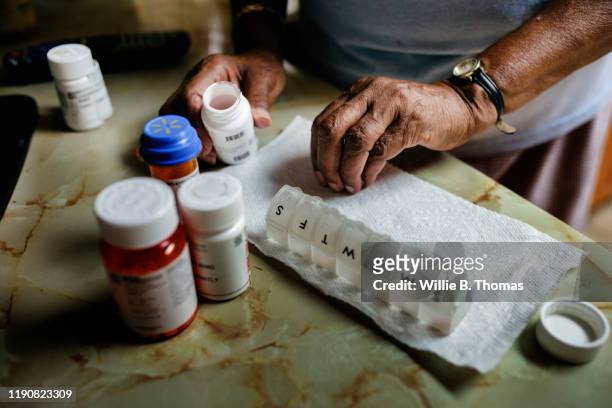 sorting weekly medication - prescription medicine stock pictures, royalty-free photos & images