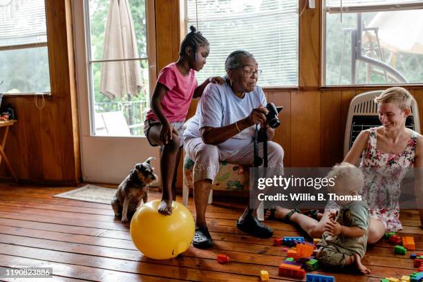 grandmother taking photos of her with grandchild - middle class female stock pictures, royalty-free photos & images