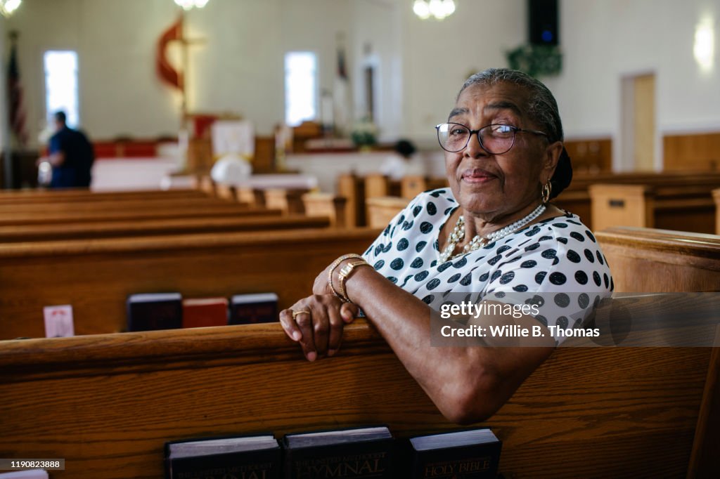 Portrait of senior black woman sitting in Church"n