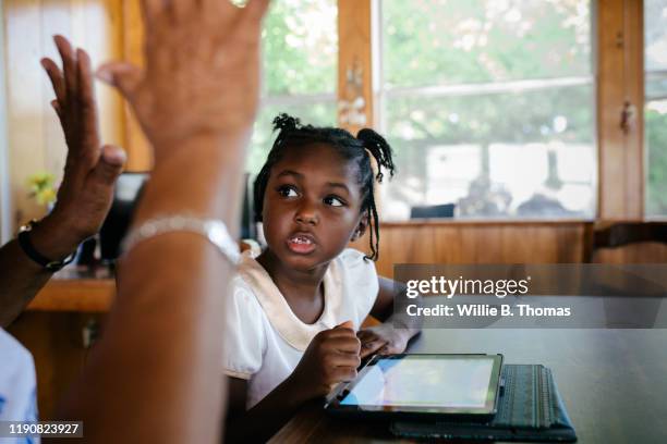 Grandmother teaching her granddaughter how to do math