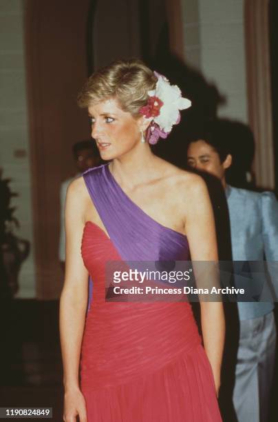 Diana, Princess of Wales attends a dinner hosted by the Crown Prince in Bangkok, Thailand, February 1988. She is wearing an evening dress by...