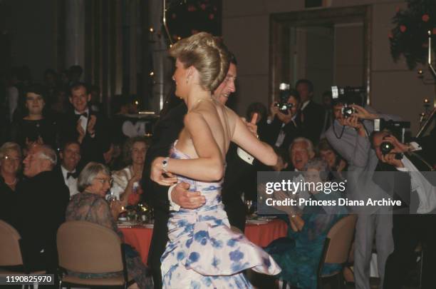 Prince Charles and Diana, Princess of Wales attend a dinner and dance in Melbourne, Australia, 27th January 1988. Diana is wearing a dress by...