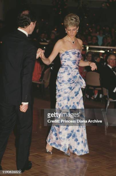 Prince Charles and Diana, Princess of Wales attend a dinner and dance in Melbourne, Australia, 27th January 1988. Diana is wearing a dress by...