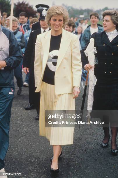 Diana, Princess of Wales attends the start of the London Marathon, 19th April 1988. She is wearing a top with the London Underground symbol on it. On...