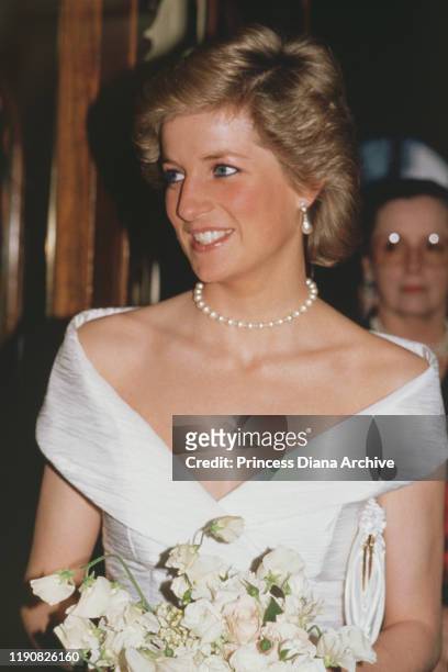 Diana, Princess of Wales attends an English National Opera production of Mozart's 'The Magic Flute' at the London Coliseum, May 1988. She is wearing...