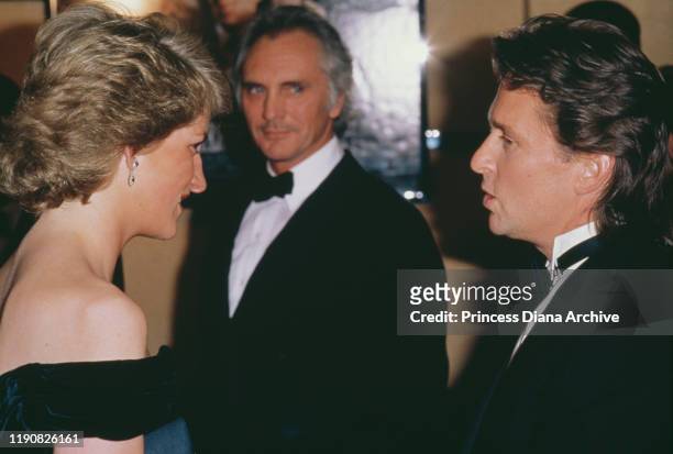 Diana, Princess of Wales talking to American actor Michael Douglas at the London premiere of the film 'Wall Street', 28th April 1988. British actor...