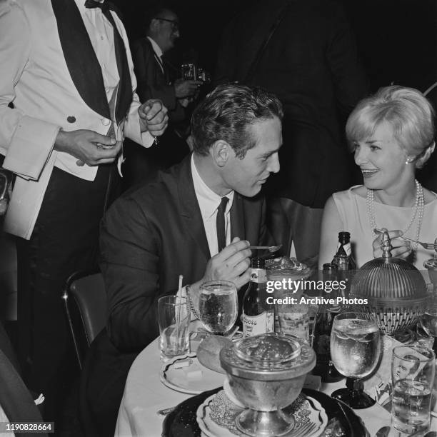 American actor Paul Newman and his wife, actress Joanne Woodward at an event, circa 1963.