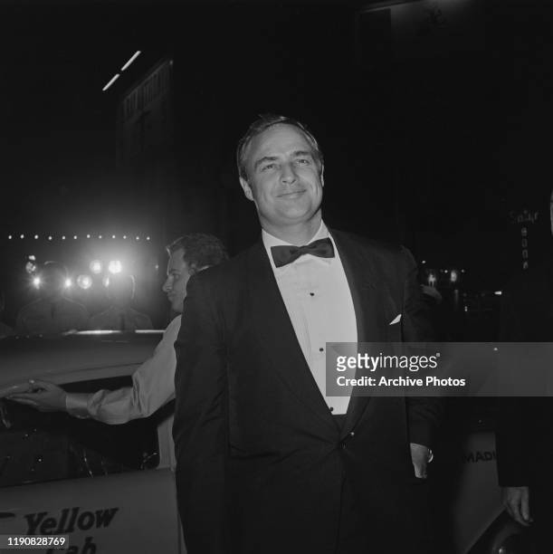 American actor Marlon Brando gets out of a Yellow Cab at the premiere of the film 'The Ugly American', USA, 1963.