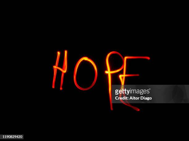 "hope" written with red light on a black background - light at the end of the tunnel stock pictures, royalty-free photos & images