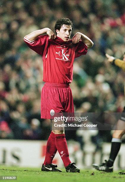 Robbie Fowler of Liverpool shows his support for the dockers strikes during the European Cup Winners Cup quarter-final match against SK Brann played...