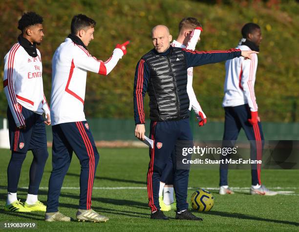 Arsenal Interim Head Coach Freddie Ljungberg with Mesut Ozil during a training session at London Colney on November 29, 2019 in St Albans, England.