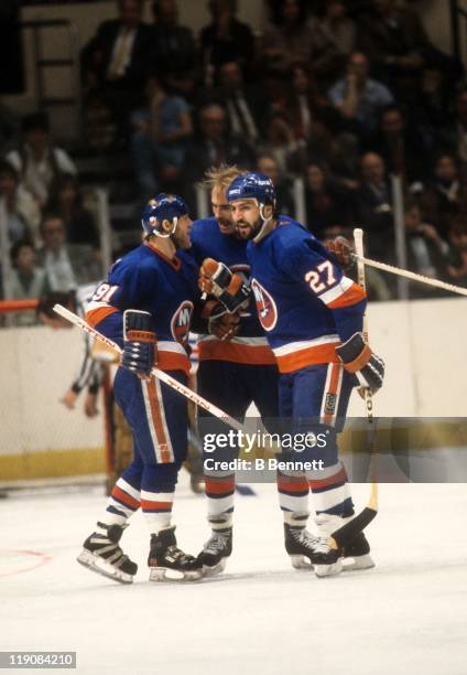 John Tonelli, Butch Goring and Bob Nystrom of the New York Islanders celebrate a goal during their game circa 1979.