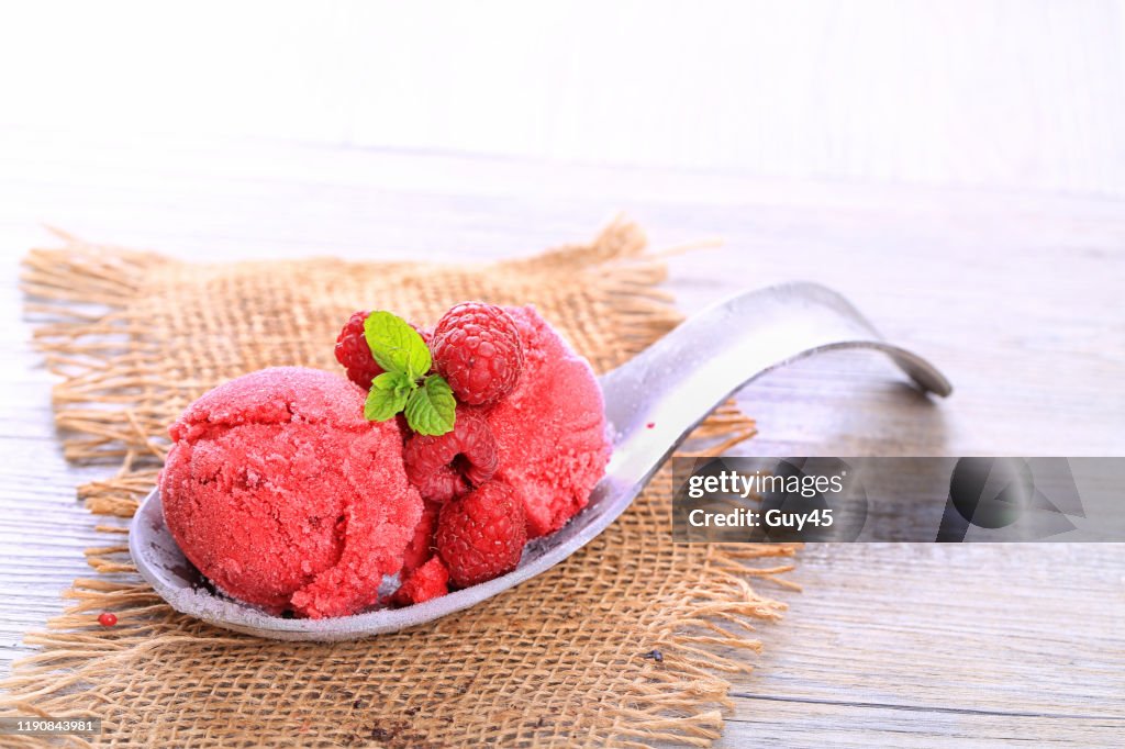 Raspberry ice cream on wooden background