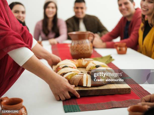 family celebrating epiphany together - rosca de reyes stock pictures, royalty-free photos & images