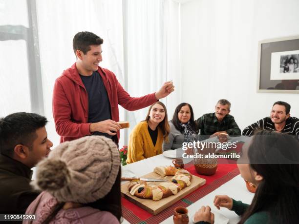 hombre mexicano sosteniendo estatuilla de hachís tradicional de reyes - rosca de reyes fotografías e imágenes de stock