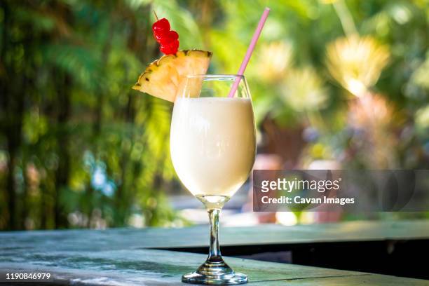 delicious pineapple cocktail in table - daiquiri stock-fotos und bilder