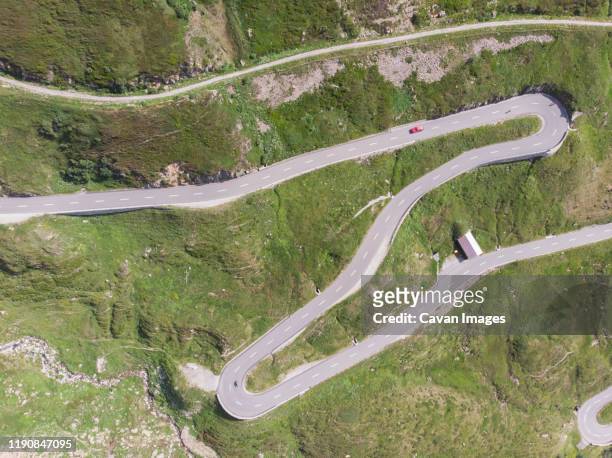 a winding and twisting road through the swiss mountains - car and motorcycle on mountain road stock pictures, royalty-free photos & images