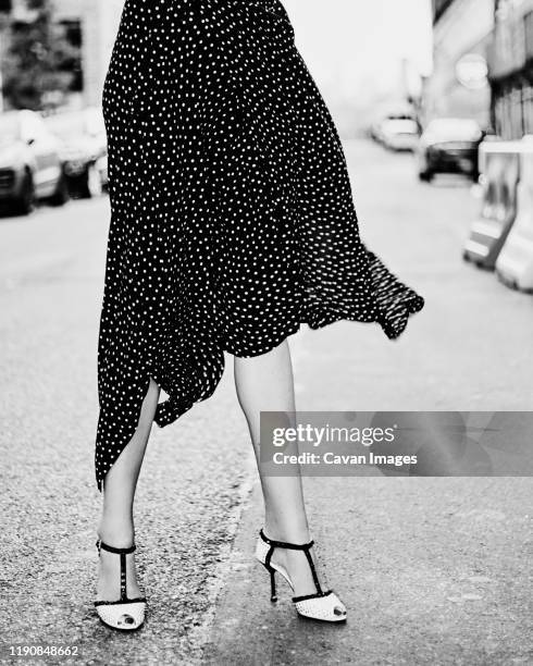 polkadot skirt blowing in the wind - leggy blonde women stock pictures, royalty-free photos & images
