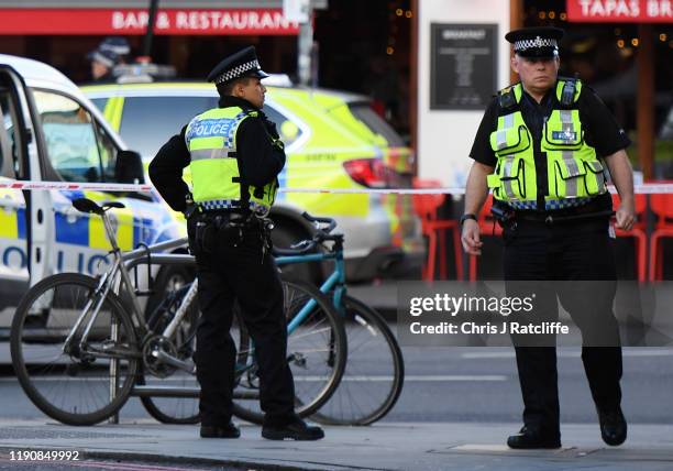 Traffic is stopped and members of the public are held behind a police cordon near Borough Market after reports of shots being fired on London Bridge...