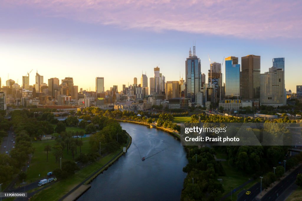 Sunset view of Yarra river and Melbourne skyscrapers business office building with evening skyline in Victoria, Australia. Australia tourism, modern city life, or business finance and economy concept