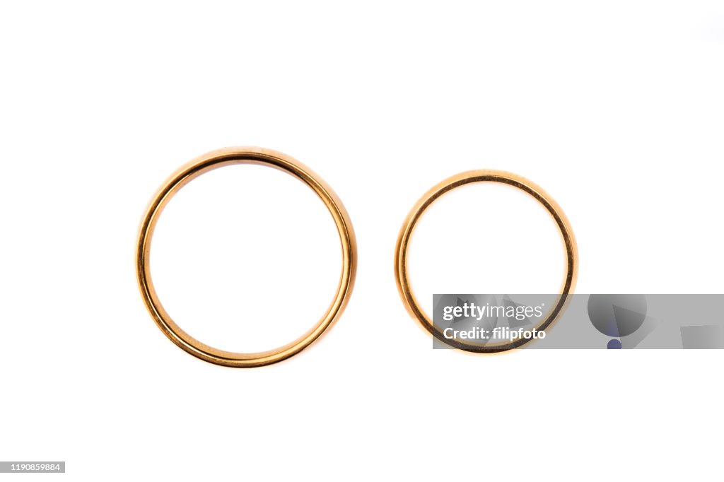 Two golden wedding rings isolated on white, wedding rings background concept