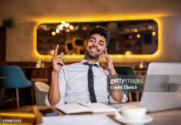 entrepreneur enjoying music on a break from work. - clicking fingers stock pictures, royalty-free photos & images