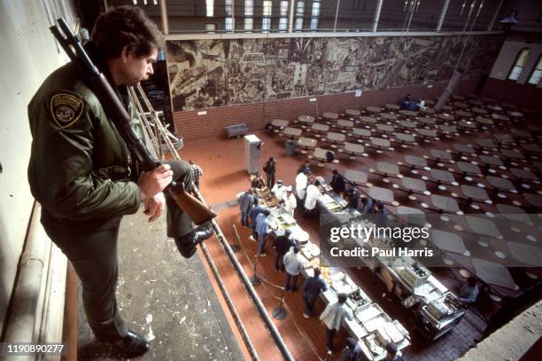 An armed guard maintains security as lunch time starts in San Quentin State Prison which is a California Department of Corrections and Rehabilitation...