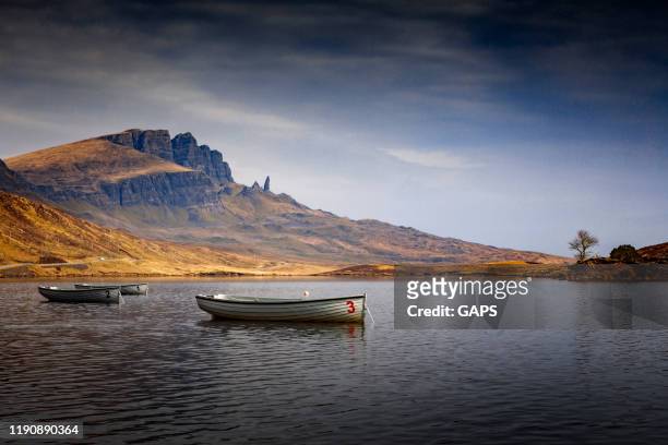 rowboats on loch leathan near the old man of storr on the isle of skye - old man of storr stock pictures, royalty-free photos & images