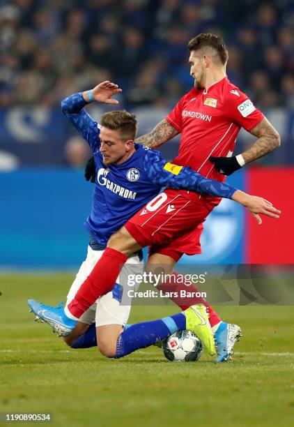 Bastian Oczipka of FC Schalke 04 is tackled by Robert Andrich of 1. FC Union Berlin during the Bundesliga match between FC Schalke 04 and 1. FC Union...