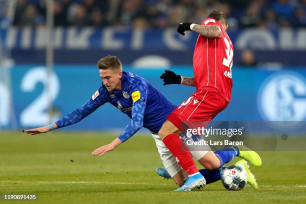 Bastian Oczipka of FC Schalke 04 is tackled by Robert Andrich of 1. FC Union Berlin during the Bundesliga match between FC Schalke 04 and 1. FC Union...