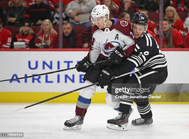 Jonathan Toews of the Chicago Blackhawks pressures Nathan MacKinnon of the Colorado Avalanche at the United Center on November 29, 2019 in Chicago,...