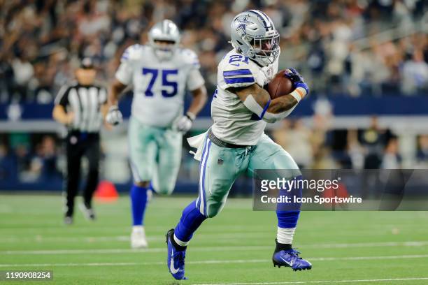 Dallas Cowboys running back Ezekiel Elliott runs through the line of scrimmage during the game between the Dallas Cowboys and the Washington Redskins...