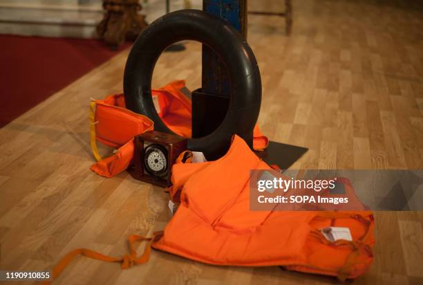 Float and life jackets are seen next to the cross of Lampedusa during a vigil organised by members of catholic diocese in solidarity with the...